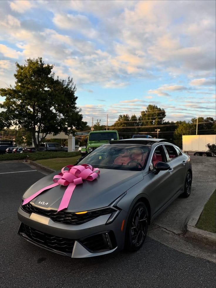 A client's new car with a pink bow after getting approved